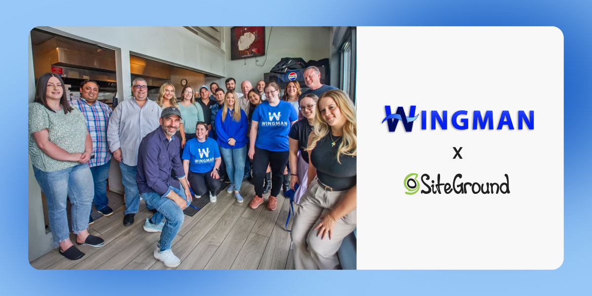 A photo of Wingman Planning's team standing together in an office setting, with several people wearing blue Wingman branded t-shirts. The image includes both the Wingman and SiteGround logos displayed prominently.